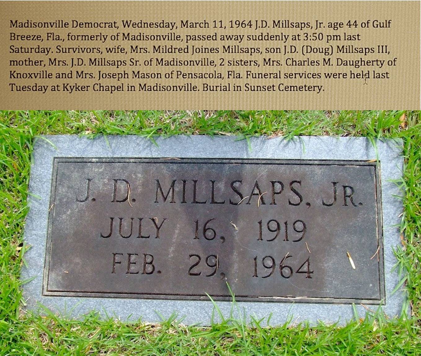 A stone plaque in the grass  Description automatically generated